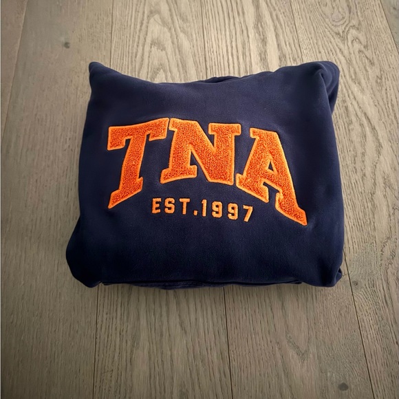 TNA Tops - TNA Dark Blue Pullover with Vibrant Orange Emblem